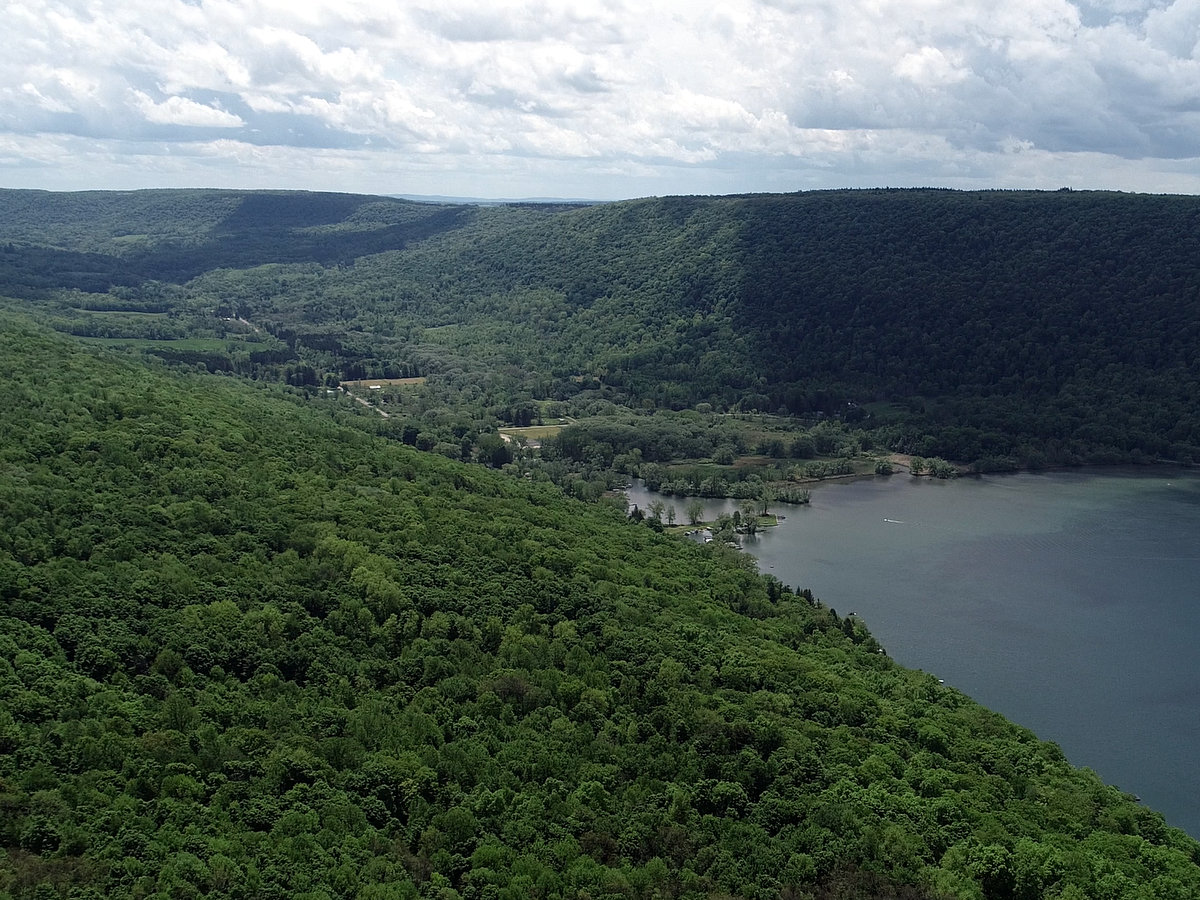 Large green hills at the end of a blue lake