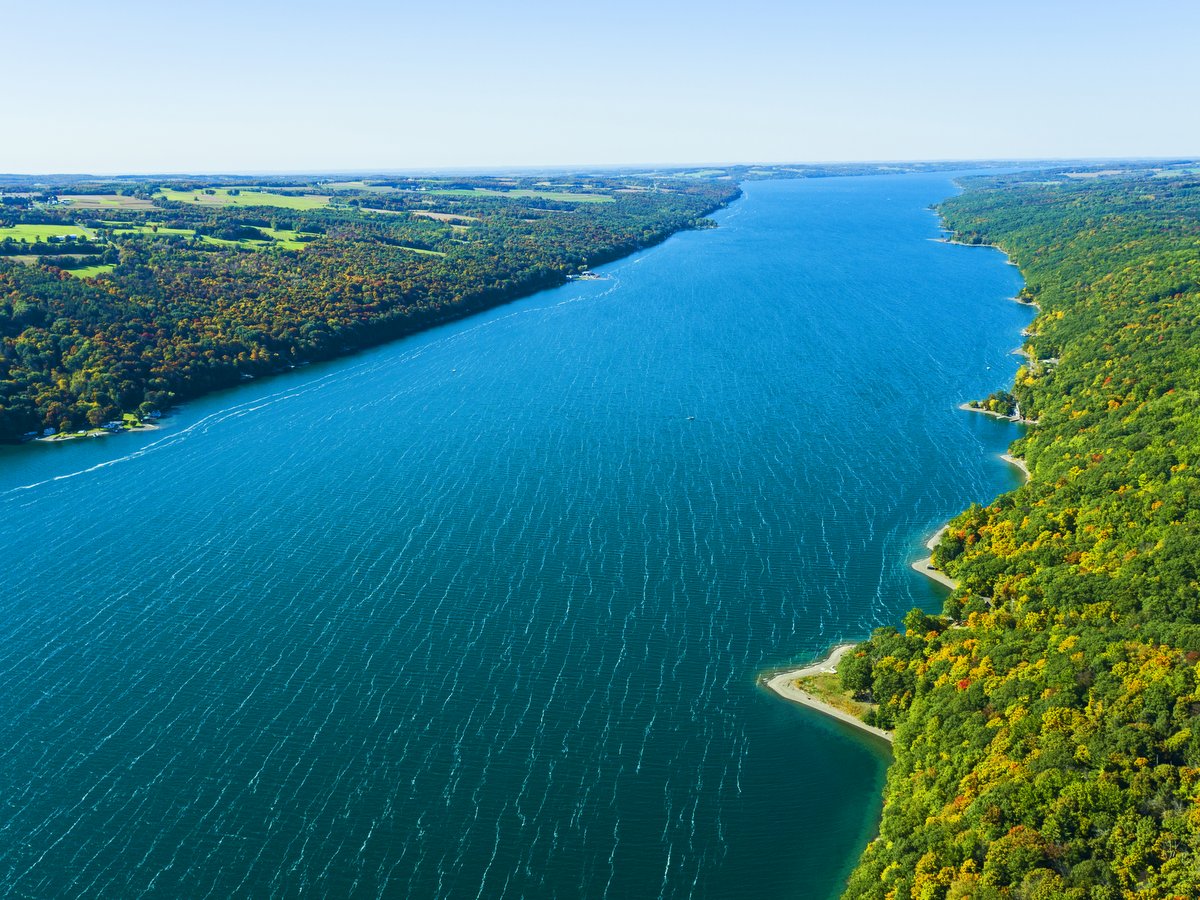 An aerial view of a long blue lake