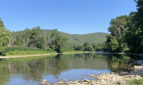 A river with green hills in the distance