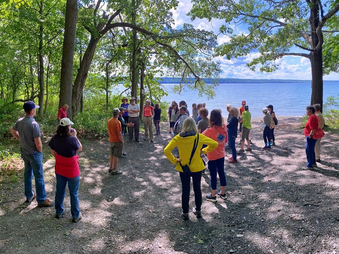 People standing on the shore of a lake