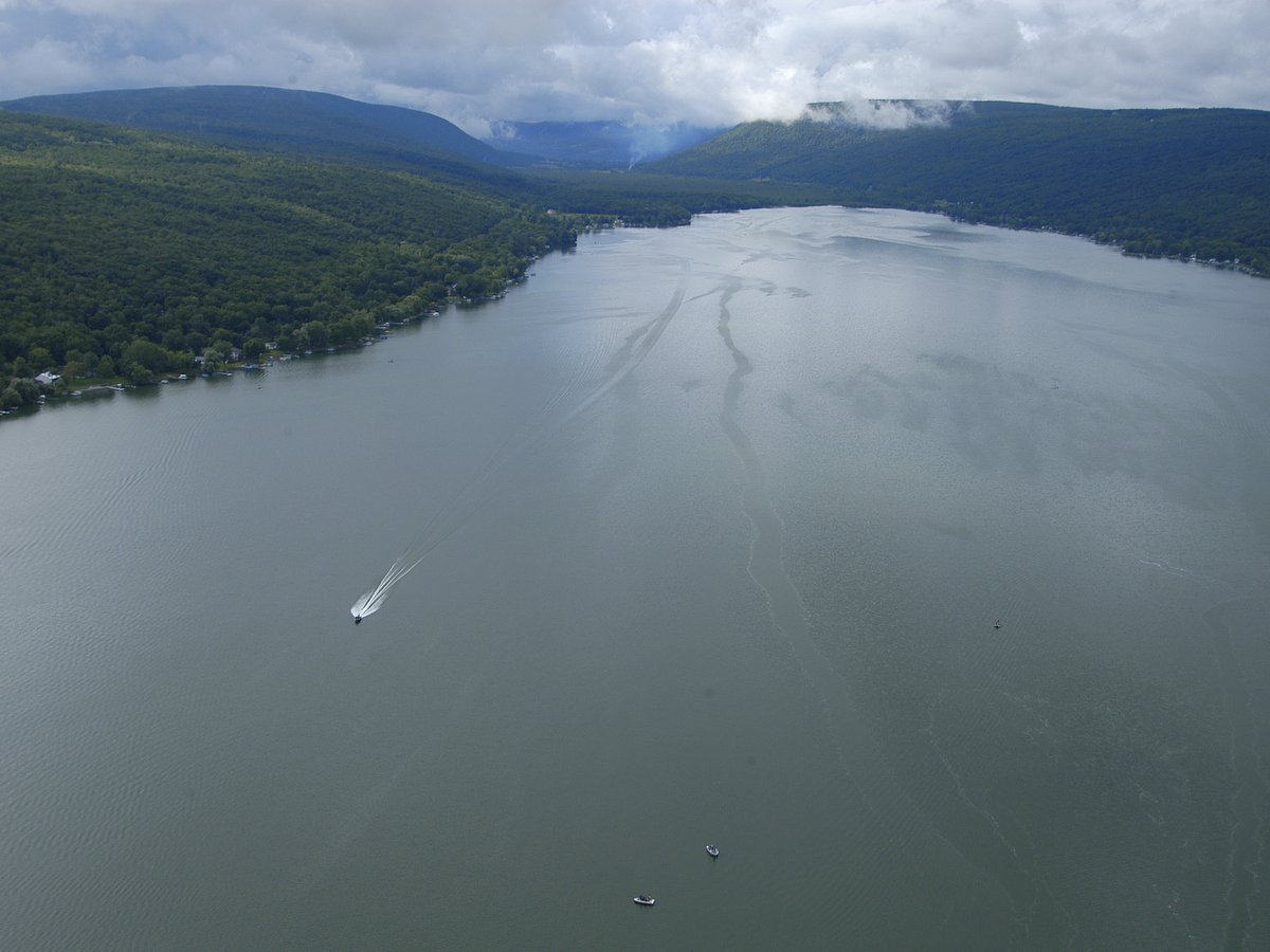 An aerial view of a lake and surrounding hills