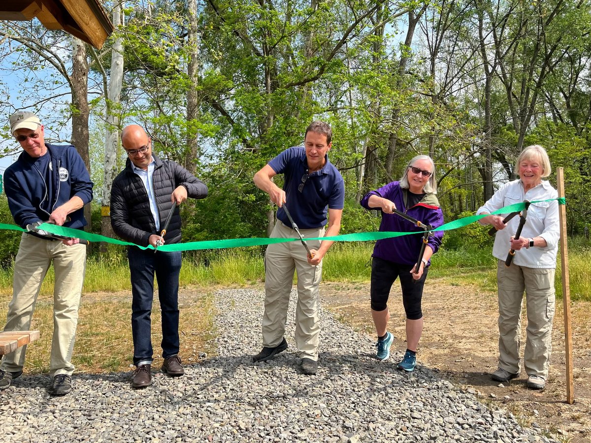 People cutting a ribbon during the dedication ceremony.