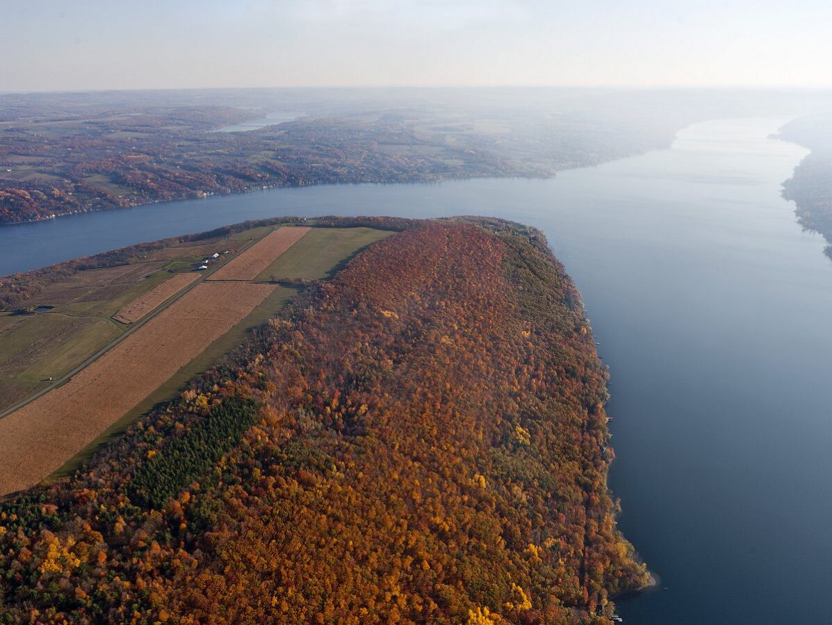 An aerial photo of a bluff overlooking a lake