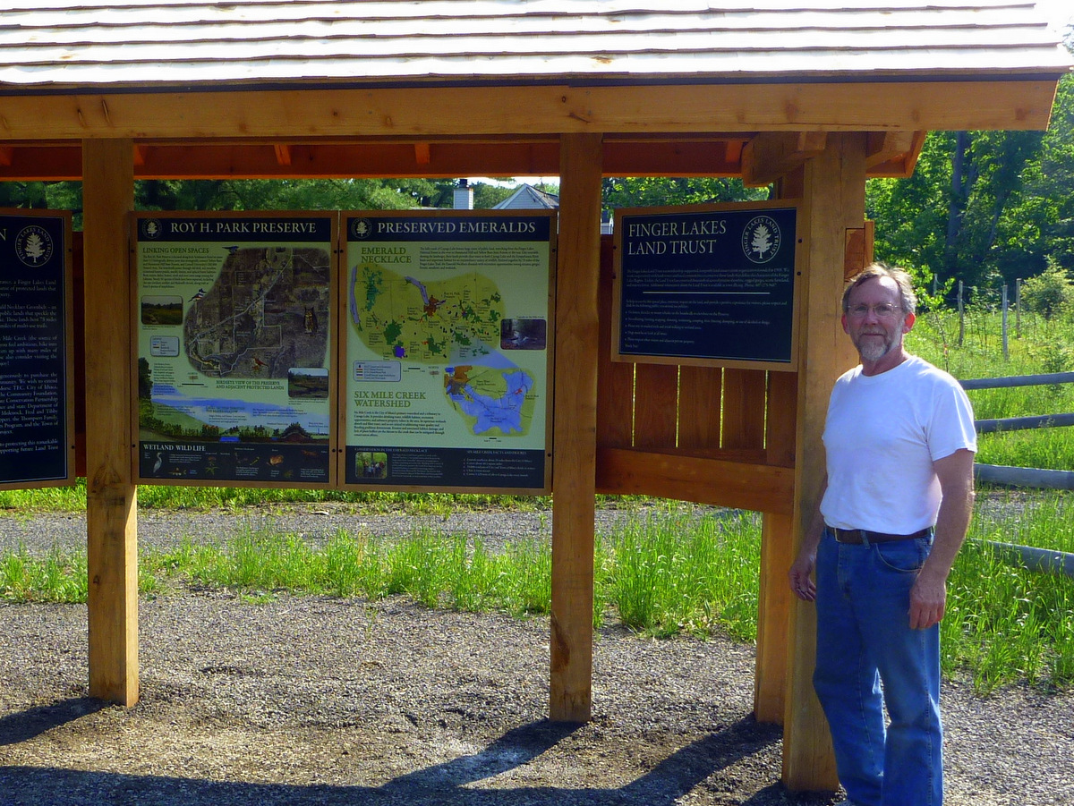 A person standing next to an informational kiosk